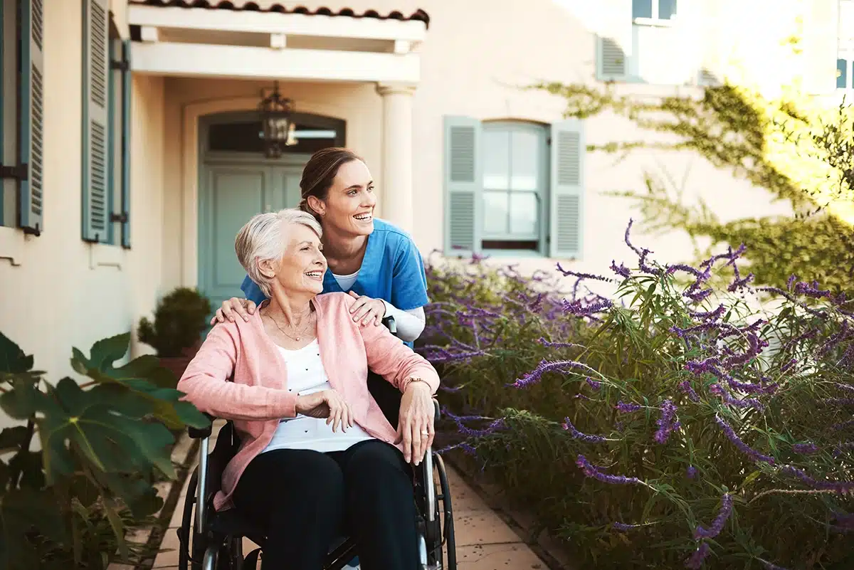Professional Carer taking care of an elderly patient at home in her garden